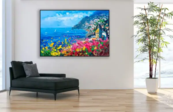 A vibrant Positano landscape painting by Agostino Veroni styled in a modern home office with a black chaise longue, perfect for creative inspiration.