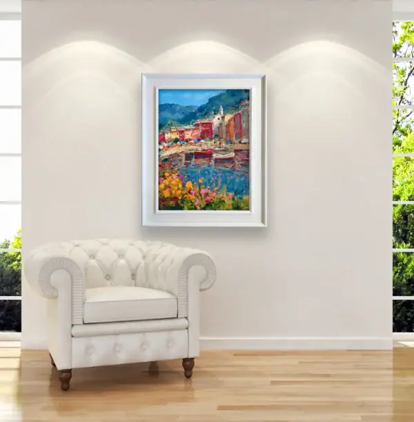 Authentic Portofino oil painting by Agostino Veroni with a white modern wood frame, showing the harbor with colorful houses and wooden boats in a contemporary living-room.
