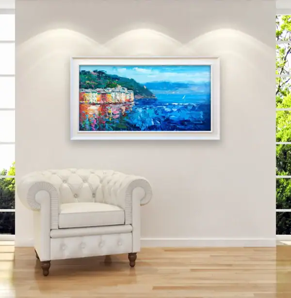 The original Portofino oil painting elegantly positioned above a classic white leather armchair, emphasizing the artwork's scale and its bright, inviting coastal atmosphere.