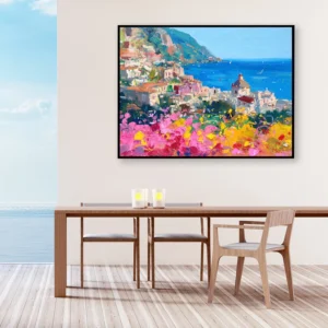 Positano floral foreground oil painting on canvas displayed above a dining table, vibrant flowers in the foreground with a luminous coastal view and deep blue sea.