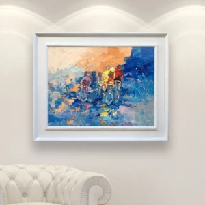 Bicycle race oil painting on canvas displayed in a bright modern interior, framed artwork showing cyclists racing with dynamic brushstrokes and vibrant blue and warm color tones