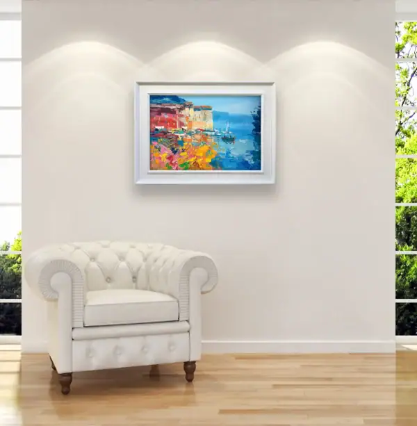 Original Italian coastal oil painting of Portofino by Agostino Veroni styled in a sophisticated office with a white armchair.