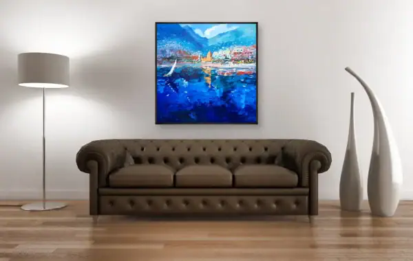 Agostino Veroni's original oil painting of a sailboat in Positano, displayed above a classic brown leather Chesterfield sofa, highlighting the deep blue tones.
