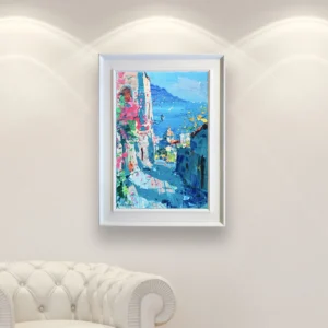 Positano vertical street view oil painting on canvas displayed in a bright interior, showcasing an ascending coastal street with blue sea in the background and colorful Italian architecture.