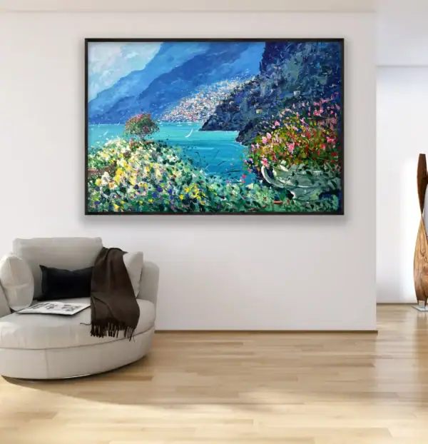 Original Positano landscape painting by Agostino Veroni displayed in a bright modern room above a white designer armchair and wooden floor.