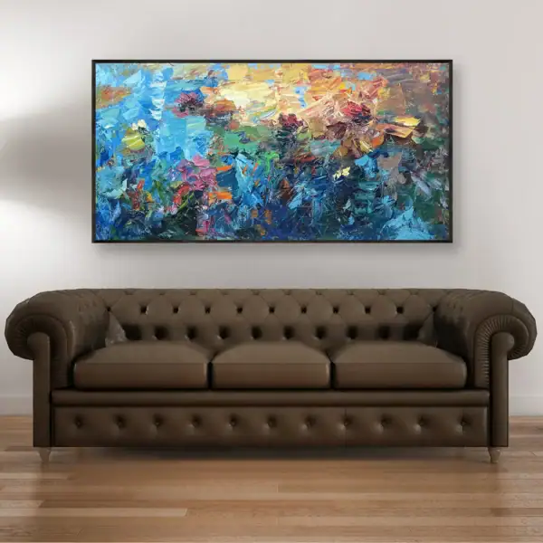 The large horizontal water lilies oil painting displayed in a modern living room above a classic brown Chesterfield leather sofa, artwork by Agostino Veroni.