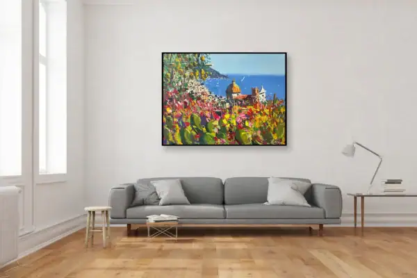 Original Positano landscape painting with vibrant cactus and floral details by Agostino Veroni, shown in a contemporary living room setting above a grey fabric sofa.