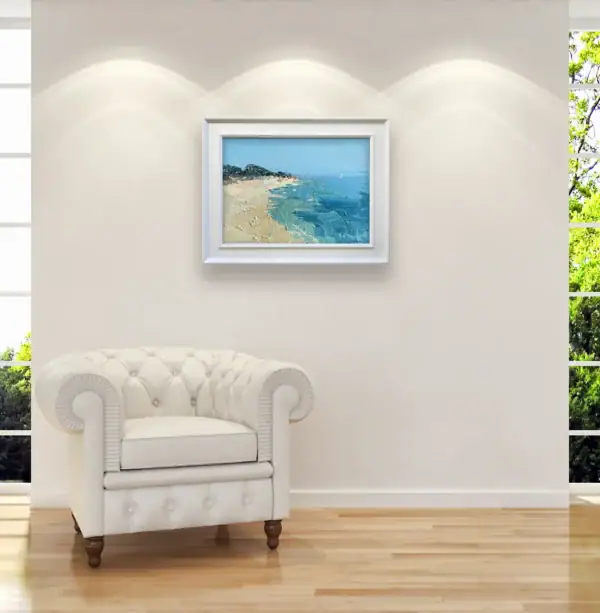 Sunny Mediterranean beach painting on canvas in a bright room with a white armchair, demonstrating a fresh and modern coastal lifestyle aesthetic.
