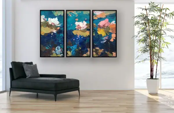 Authentic floral triptych by Agostino Veroni with thin black frames, hanging on a white wall in a bright home office or living-room next to a black modern chaise longue.