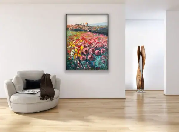 A vertical original oil painting of the Florence skyline and roses by Agostino Veroni, hanging in a bright, modern minimalist living room above a white armchair.