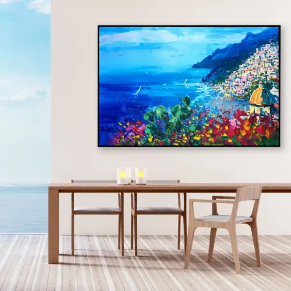 Original oil painting of Positano by Agostino Veroni in a modern dining room setting with a wooden table, overlooking a balcony with a sea view.