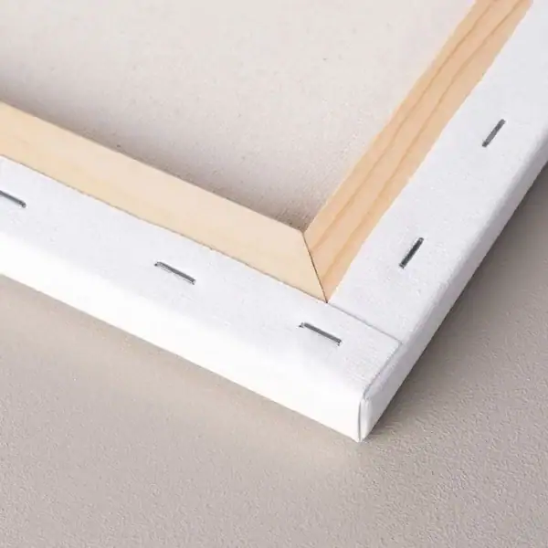 Back detail of a stretched canvas mounted on wooden stretcher bars, showing staples and clean professional finishing