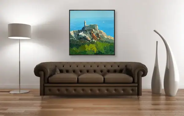 Italian coastal art displayed in a sophisticated room setting next to a dark leather Chesterfield sofa, highlighting the vibrant Mediterranean colors.