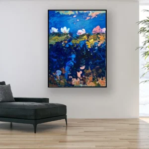 Vertical water lilies oil painting on canvas displayed above a sofa, showing floating lilies on deep blue water with soft reflections and expressive brushstrokes