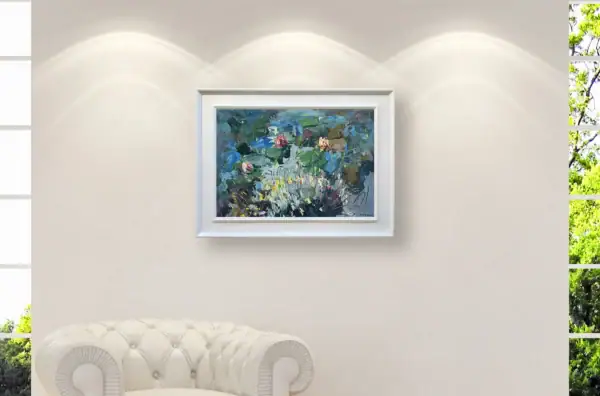 Horizontal water lilies painting in a white frame, centered on a neutral gallery wall with soft spotlight illumination.