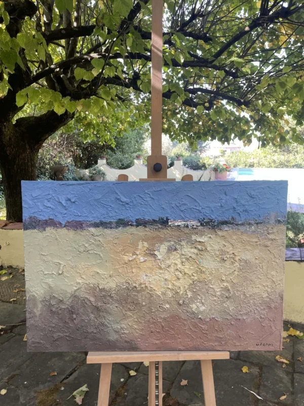 Abstract landscape oil painting on canvas by Agostino Veroni on wooden easel outdoors. Modern earth artwork in natural sunlight with green garden trees in the background.