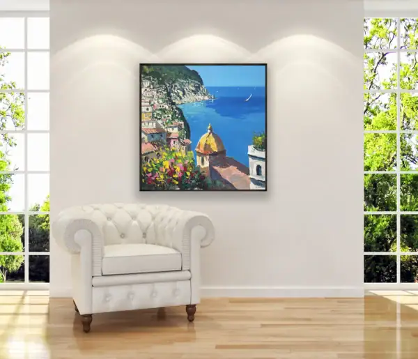 Original Positano landscape painting by Agostino Veroni displayed in a bright modern room next to a white leather armchair.