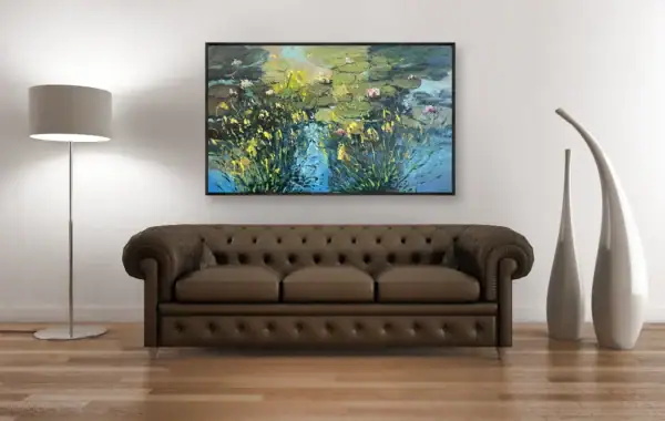 The impressionist water lilies artwork in a black frame above a classic brown leather sofa, perfect for sophisticated home decor.