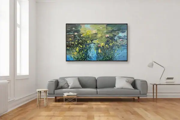 Large horizontal water lilies painting hanging above a grey modern sofa, creating a serene and elegant atmosphere in the living area.
