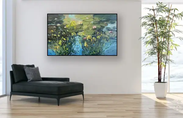 The original water lilies oil painting displayed in a minimalist room with a black designer lounge chair and bright wooden floors.