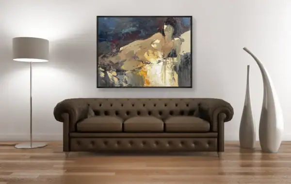The artistic reclining nude painting in a black frame hanging above a classic brown leather sofa, showcasing a sophisticated home gallery look.