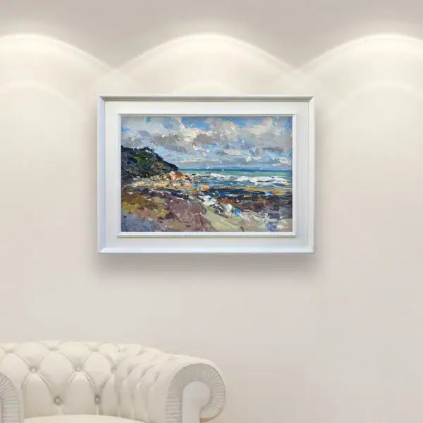 Large horizontal Mediterranean seascape painting by Agostino Veroni hanging in a bright, modern living room above a white tufted sofa.