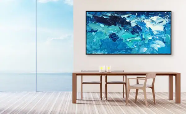 The original abstract blue waves artwork displayed in a contemporary dining room next to a large window overlooking the sea.