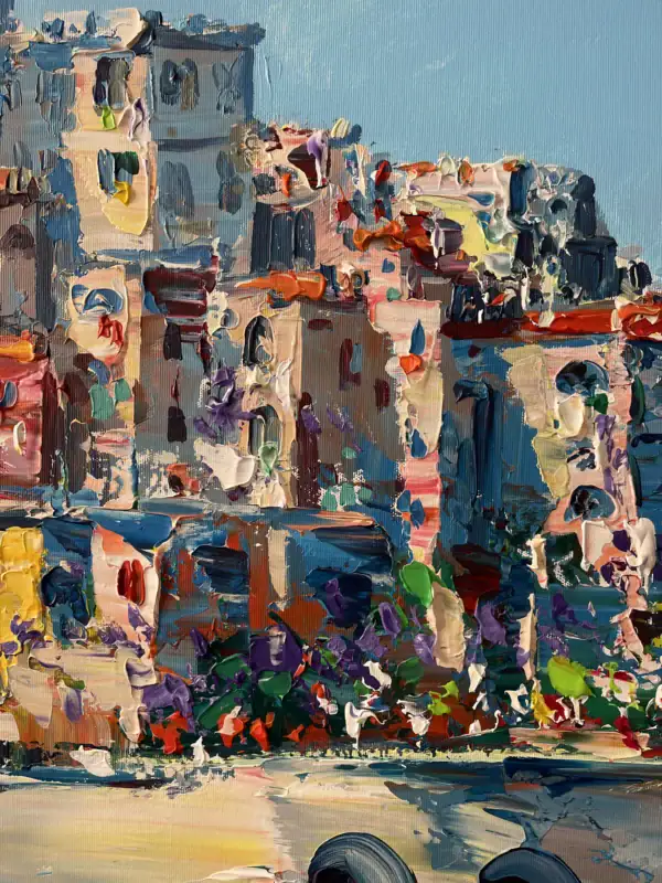 Detailed macro shot showcasing the heavy impasto texture of premium oil paint shaping the coastal village architecture stacked high against the clear sky.