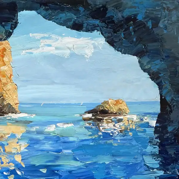 Close-up macro shot focusing on the dark rugged rocks framing the bright turquoise sea and the sunny Capri cliffs in the distance.