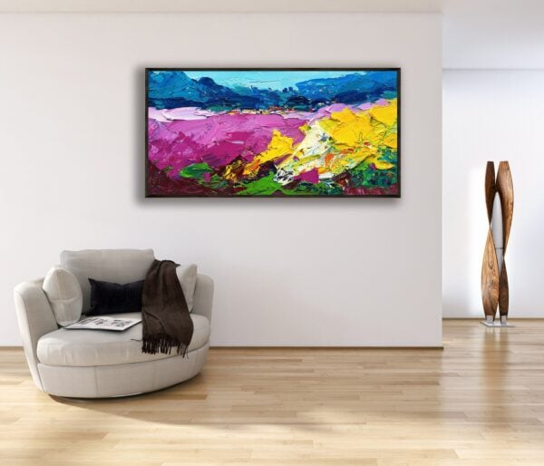 The horizontal sunflowers and lavender painting hanging in a bright contemporary room above a comfortable white armchair.