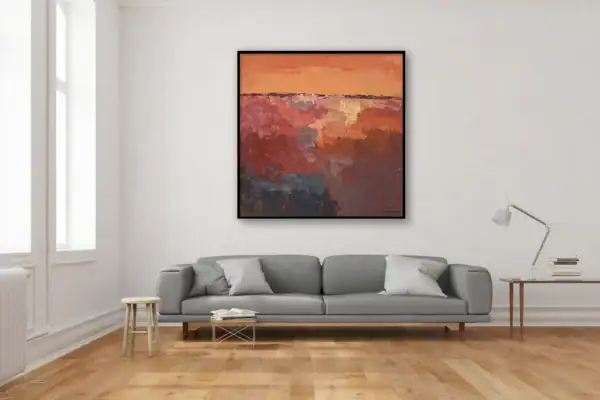 The square contemporary terracotta and grey abstract canvas hanging on a minimalist white wall above a modern grey sofa.