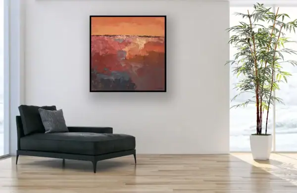 The powerful, earthy abstract painting perfectly scaled and displayed next to a sleek black chaise longue in a professional creative workspace.