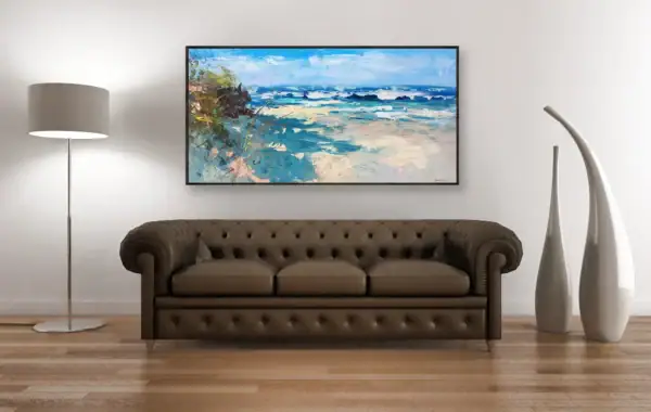 The large horizontal beach painting shown in an elegant interior setting above a brown leather Chesterfield sofa with decorative tall vases.