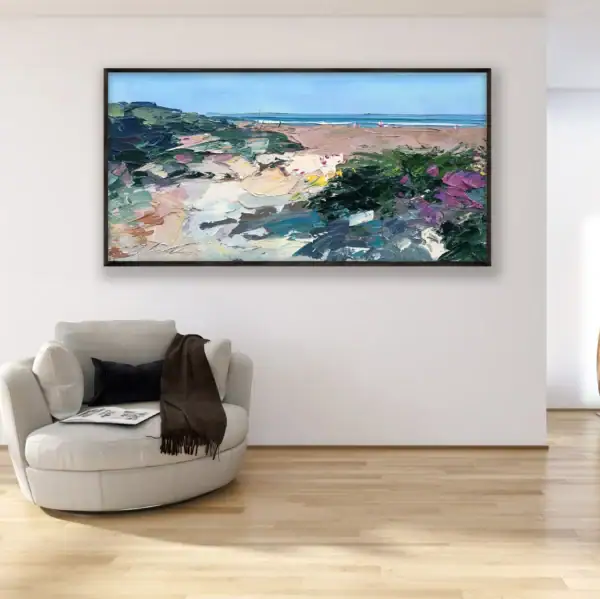 A large horizontal original oil painting of a beach landscape by Agostino Veroni, hanging in a bright modern room above a stylish white armchair.
