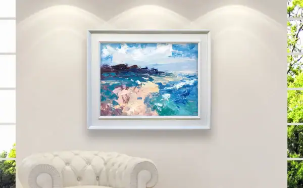 A sophisticated bright interior view showing the framed ocean landscape painting perfectly scaled and highlighted under soft spotlights.