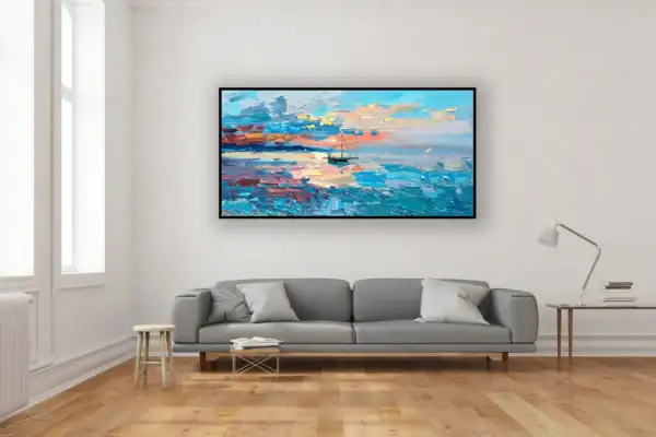 The horizontal sunset seascape canvas hanging beautifully on a clean white wall above a contemporary grey sofa in a stylish apartment.
