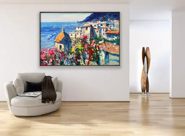 The horizontal Positano oil painting styled as a focal point on a neutral wall in a modern living room interior with a contemporary armchair and elegant decor.