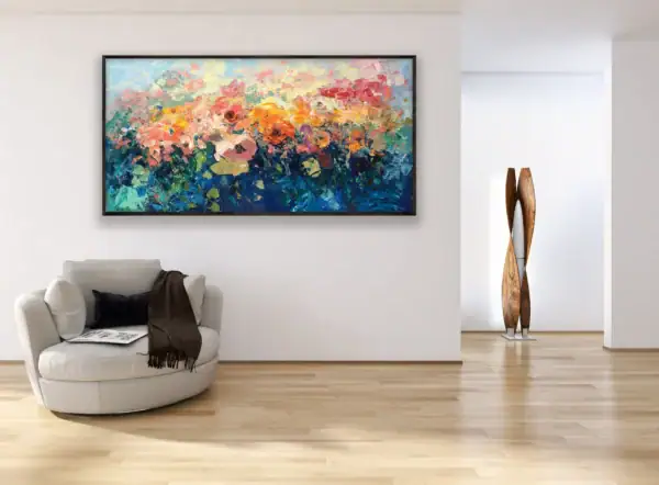 The horizontal textured rose garden artwork styled in a bright elegant room above a contemporary white armchair.