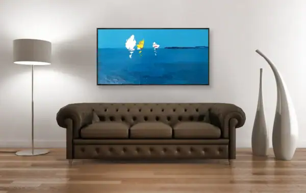A large horizontal minimalist sailing oil painting hanging on a white wall in an elegant room with a brown leather sofa.