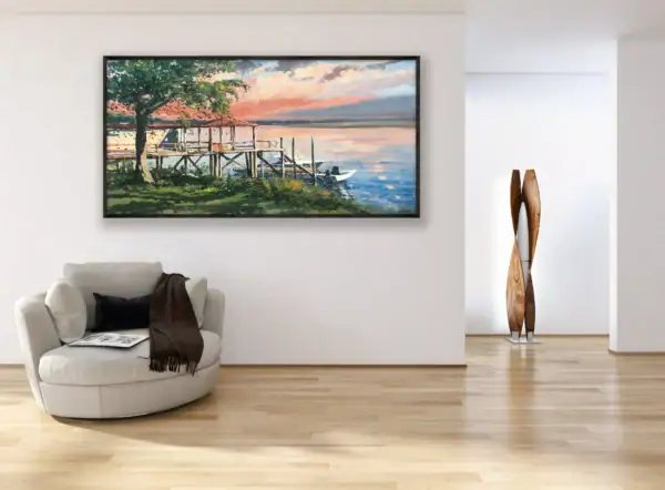 The large horizontal Savannah coastal view painting hanging elegantly on a clean white wall above a modern rounded armchair.