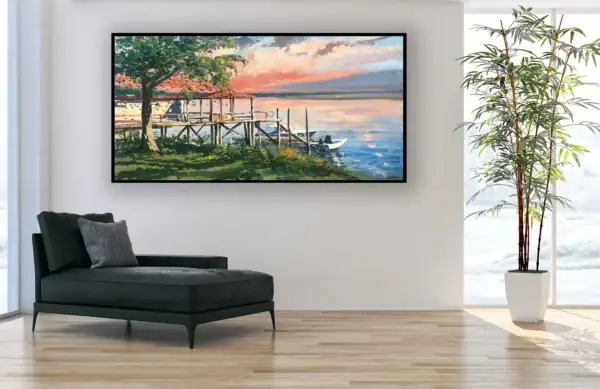 The horizontal Southern coastal landscape canvas styled beautifully in a bright contemporary room next to a sleek black leather chaise longue.