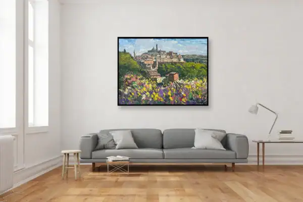 An original Siena landscape oil painting on canvas styled as a centerpiece on a neutral wall in a contemporary living room above a grey sofa.