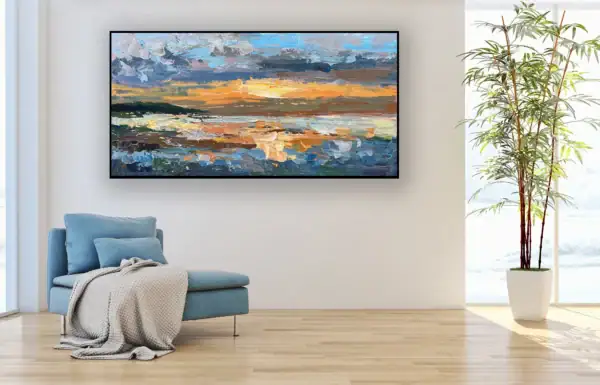 The dramatic, moody coastal artwork perfectly scaled for a sophisticated workspace next to a large potted plant.