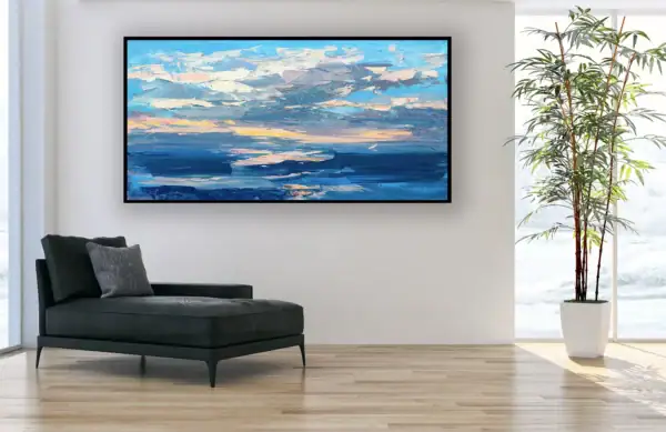 A perspective view of the horizontal marine sunset oil painting styled in an elegant room next to a black leather chaise longue and a tall indoor plant.