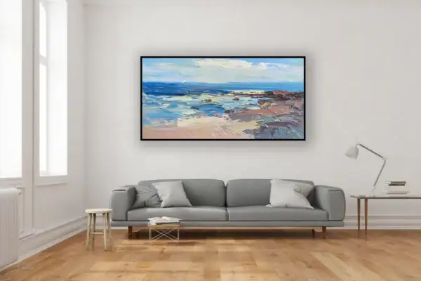 The large horizontal turquoise beach painting beautifully styled on a minimalist wall above a contemporary grey sofa.