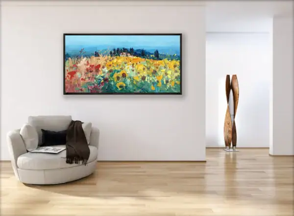 The large horizontal framed sunflower field painting shown from a perspective angle in a bright, minimalist modern home interior.