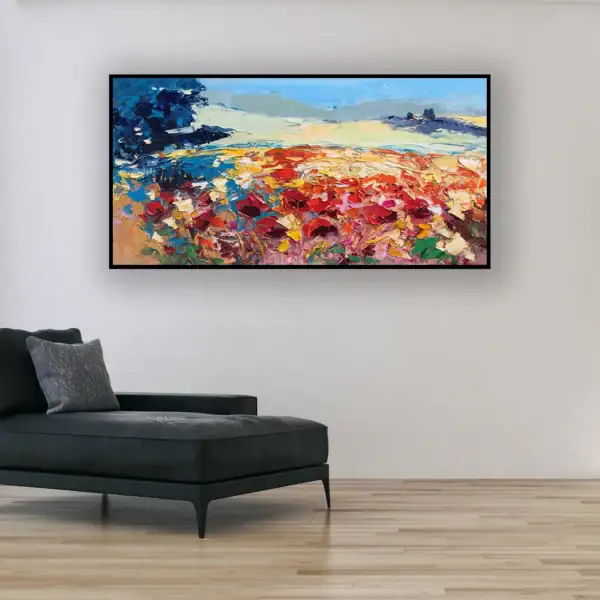 The large horizontal red poppy field canvas hanging beautifully on a minimalist light wall above a modern black chaise longue.
