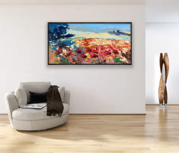 A frontal perspective view of the horizontal Tuscan countryside artwork styled in a bright elegant room above a cozy armchair.