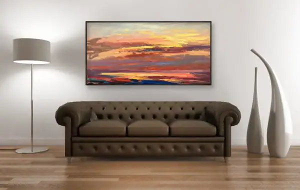 A frontal perspective view of the fiery abstract landscape painting hanging above a dark brown leather Chesterfield sofa.