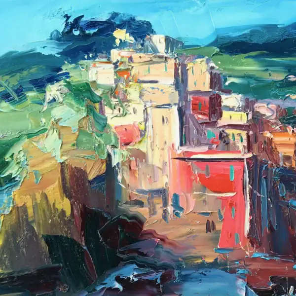 Close-up macro view focusing on the vibrant red, orange, and golden historical houses stacked together on the steep Ligurian cliff.